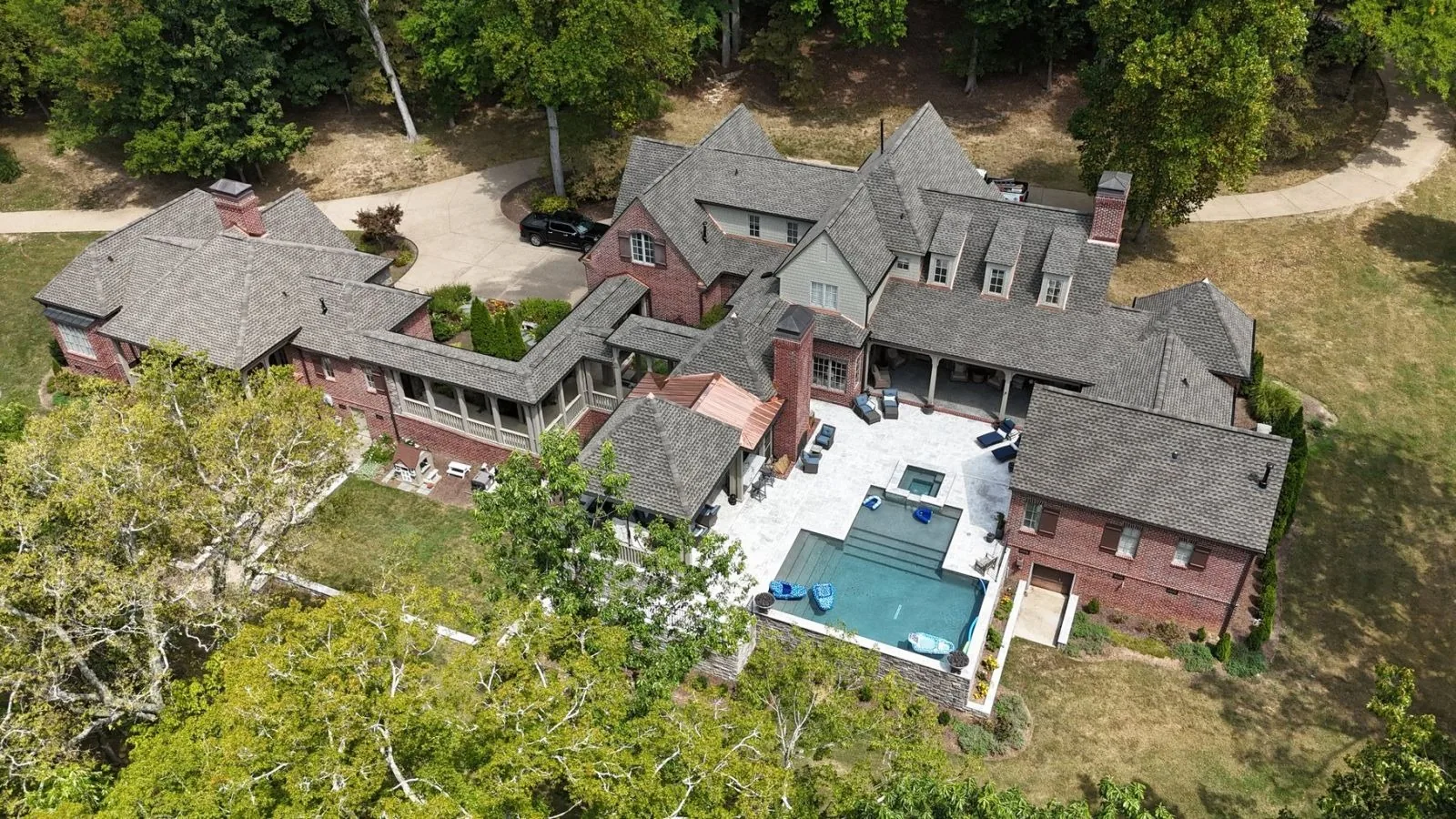 Aerial view of an estate with a new architectural shingle roof installed by Three Stone